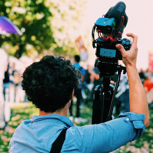 Mann mit Filmkamera auf der Schulter